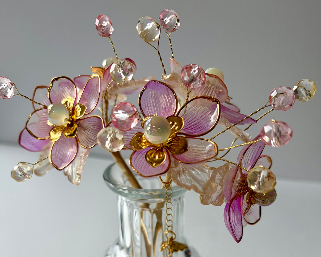 Close up detail of handcrafted blue beaded flowers with gold accents