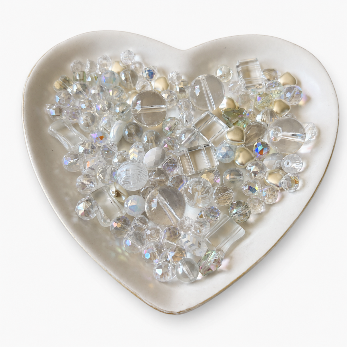 Crystal Kiss Luxe Mix glass bead assortment in a heart-shaped dish on a white background