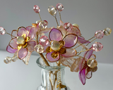Close up detail of handcrafted blue beaded flowers with gold accents