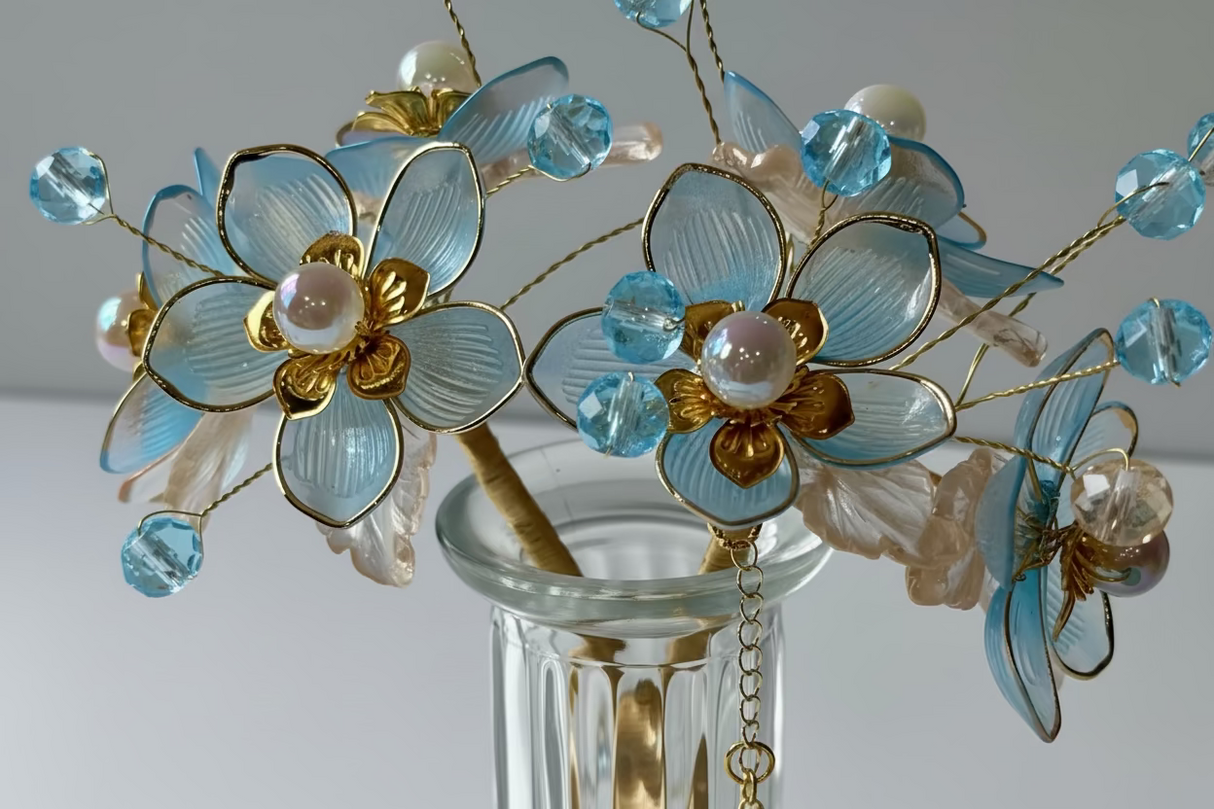 Close-up detail of handcrafted blue beaded flowers with gold accents 
