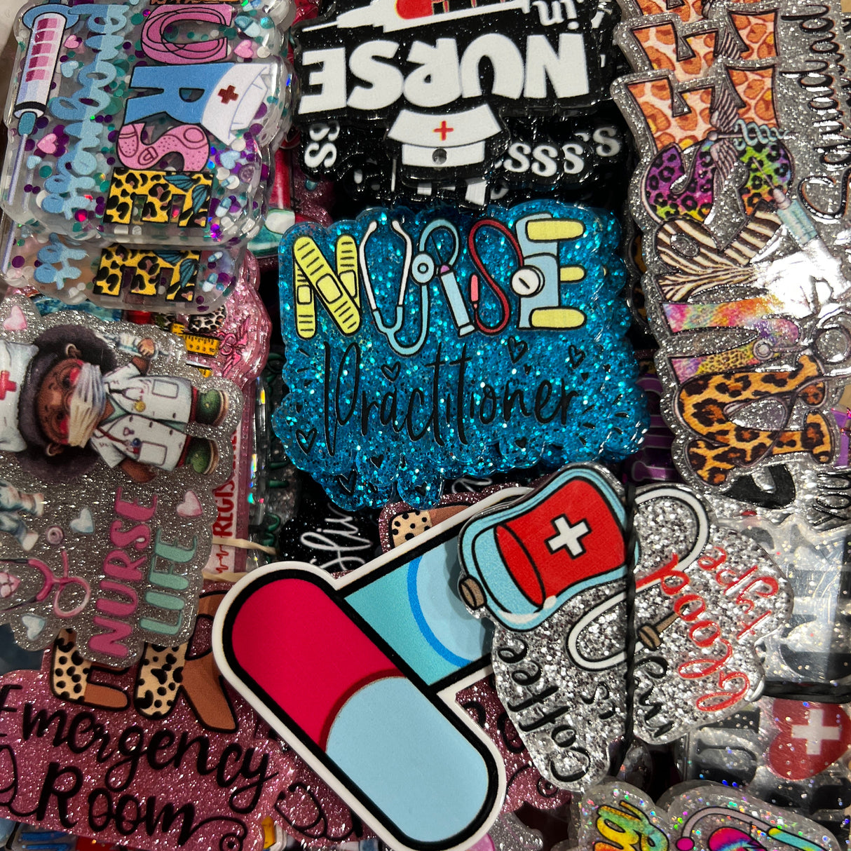 Collection of colorful pins with various designs, including 'Nurse' and medical symbols.