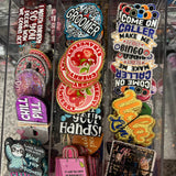 Collection of colorful pins and stickers in a clear display case.