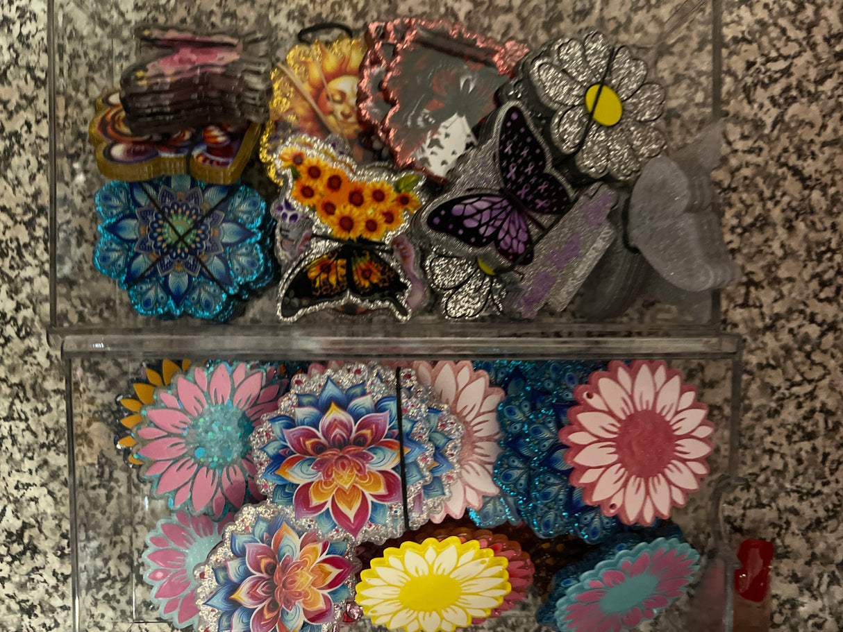 Collection of colorful floral and butterfly patches on a textured surface