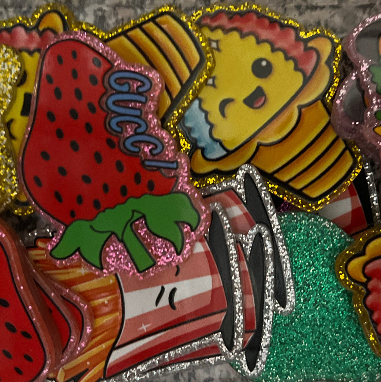 Colorful patch with ice cream, strawberry, and hamburger design on a textured surface