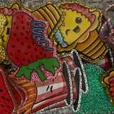 Colorful patch with ice cream, strawberry, and hamburger design on a textured surface