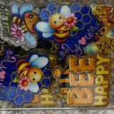 Collection of colorful bee-themed decorative magnets on a metallic surface.