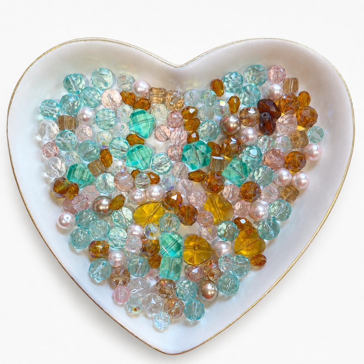 Bayou Royalty Luxe Mix glass bead assortment in a heart-shaped dish on a white background