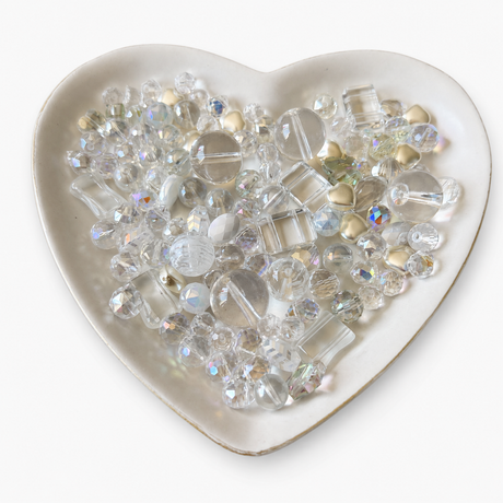 Crystal Kiss Luxe Mix glass bead assortment in a heart-shaped dish on a white background