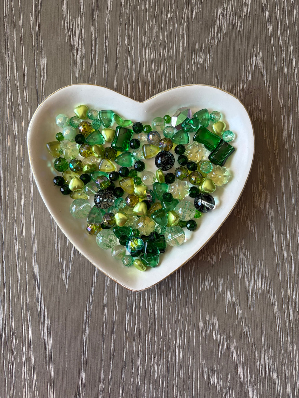 Emerald Bling Bling Lux Mix sparkling green beads displayed in heart-shaped dish