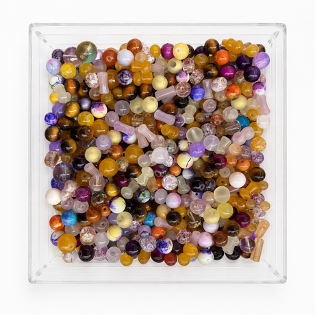 Carnival assorted bead mix in clear tray on a soft white background