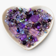 Lavender Nights Luxe Mix glass bead assortment in a heart-shaped dish on a white background