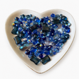Midnight Blue Luxe Mix glass bead assortment in a heart-shaped dish on a white background