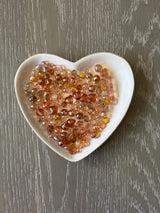 Orange Glow Bling Bling Lux Mix orange glass beads displayed in heart-shaped dish