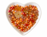 Orange Paradise Bling Bling Lux Mix orange bead assortment in heart-shaped dish on white background