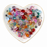 Prism Glow Glass Bead Mix translucent multicolor beads in a heart-shaped dish on a clean white background