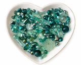 Teal Dreams Bling Bling Lux Mix teal bead assortment in heart-shaped dish on white background